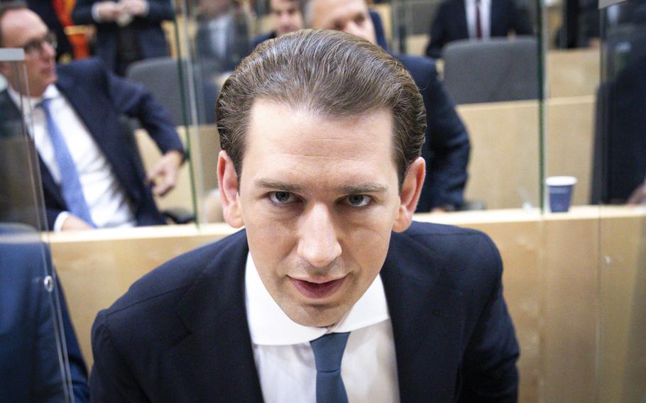 Sebastian Kurz, the former Austrian Chancellor, takes his seat before the sworn-in as deputy in the Austrian Parliament in Vienna, Austria, Thursday, Oct. 14, 2021.