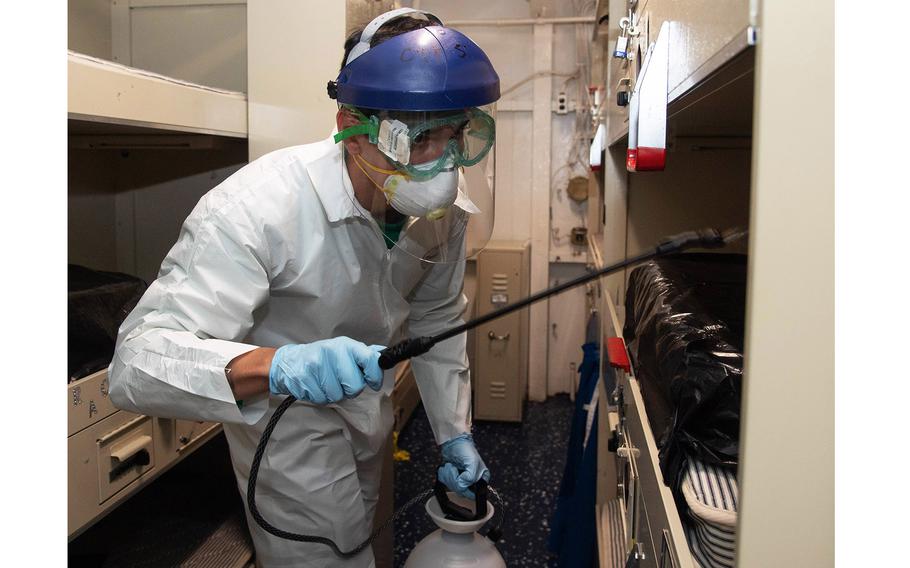 Navy Aviation Electrician’s Mate 3rd Class Kyle Hernandez, assigned to the “Tomcatters” of Strike Fighter Squadron 31, disinfects a berthing aboard the aircraft carrier USS Theodore Roosevelt on April 12, 2020.