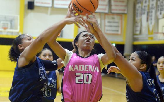 Kadena's Ayanna Levi tries to shoot between St. Paul Christian defenders during Satuday's girls championship game in the 5th American School In Japan Kanto Classic basketball tournament. The Warriors outalsted the Panthers 38-33.
