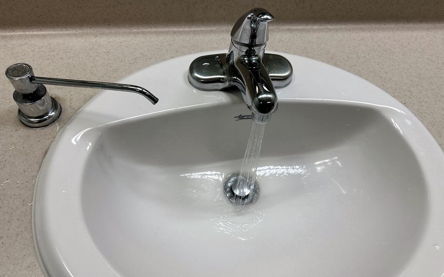 Water flows from a bathroom sink inside an office building at Camp Humphreys, South Korea, on Jan. 11, 2024.