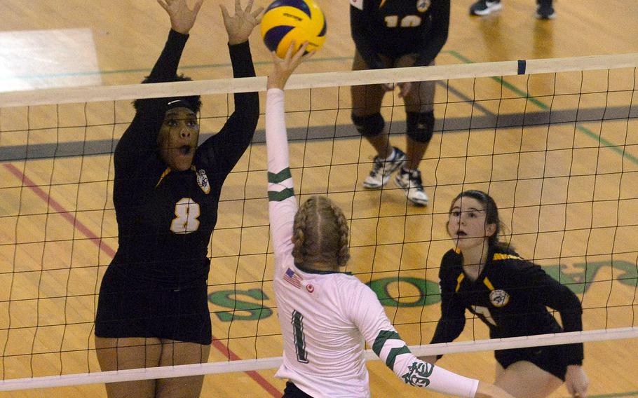 Kubasaki's Emma Leggio tries to send the ball past Kadena's Kimberly Wright and Deniz Dussetschleger during Thurday's Okinawa girls volleyball match. The Dragons won in three sets.