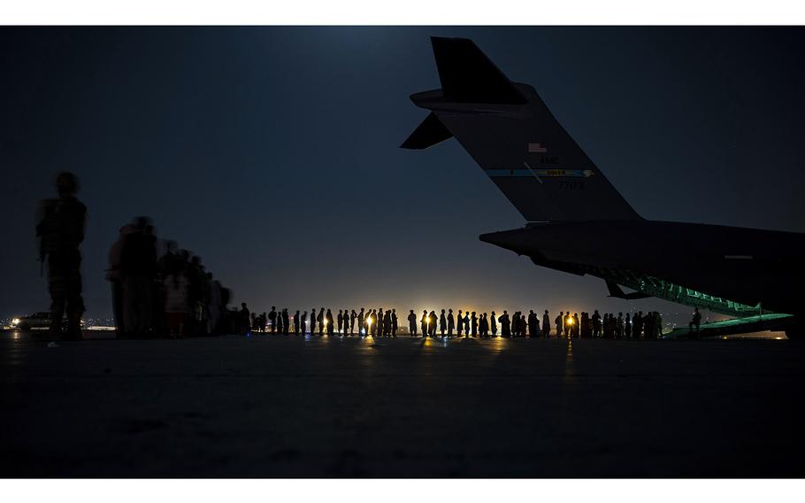 A U.S. Air Force air crew, assigned to the 816th Expeditionary Airlift Squadron, prepares to load qualified evacuees aboard a U.S. Air Force C-17 Globemaster III aircraft in support of the Afghanistan evacuation at Hamid Karzai International Airport, Kabul, Afghanistan, Aug. 21, 2021. 