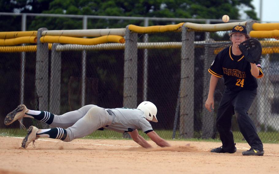 Kubasaki's Asher Romnek dives back to the bag ahead of the pickoff throw to Kadena first baseman Josiah Stuits during Monday's DODEA-Okinawa baseball game. The Dragons won 10-2.