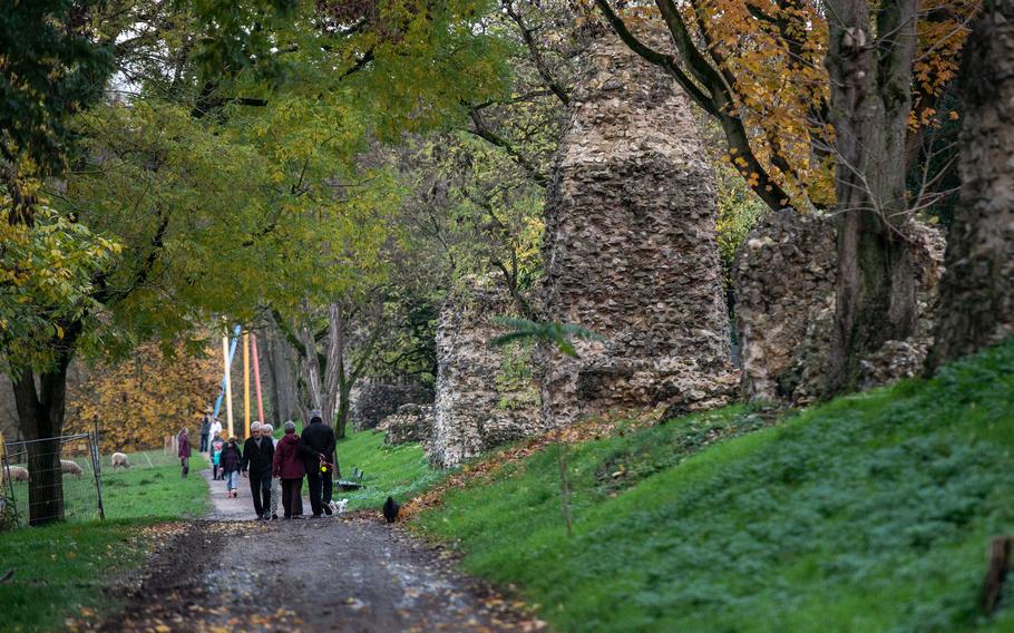 People walk past the Roman Rocks, remnants of a Roman aqueduct in Mainz, Germany, on Nov. 18, 2022. The aqueduct once delivered more than 8,000 gallons of water per day to Roman military encampments in the city.