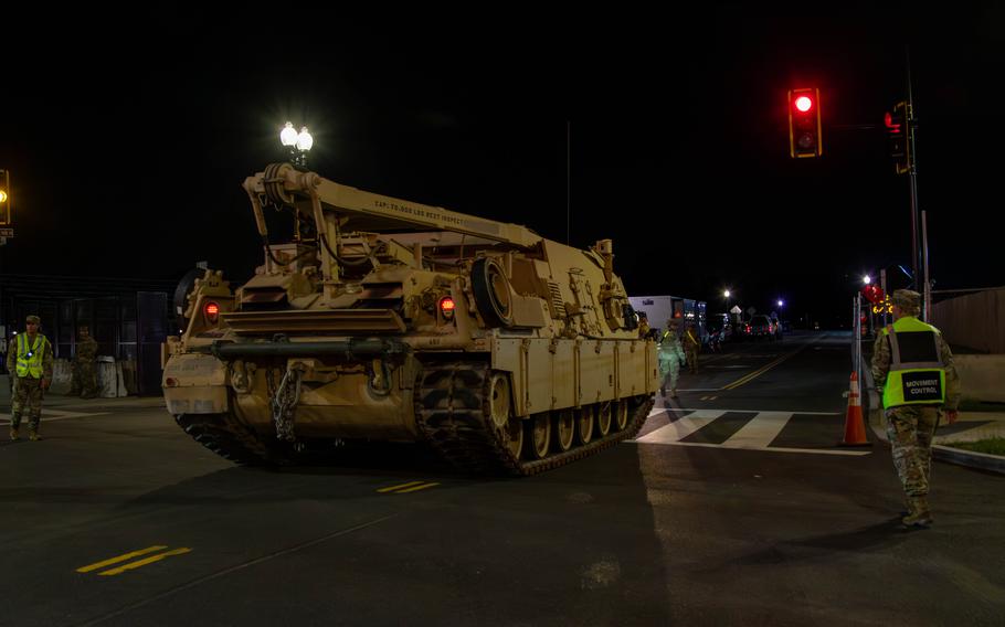 A tank rolls on a street