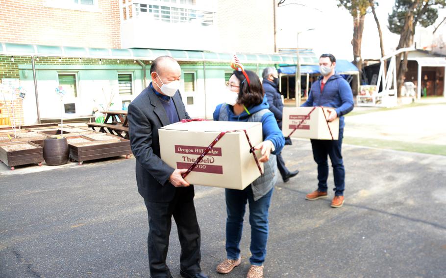 Eighth Army soldiers unload donated gifts at Namsan-won Orphanage in Seoul, South Korea, Thursday, Dec. 23, 2021.