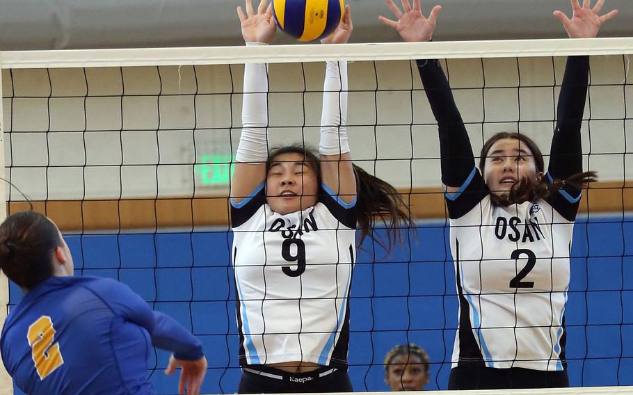 Yokota's Malia Hutchins spikes against Osan's Clarice Lee and Hanna Rutland during Tuesday's Division II pool play match. The Panthers won in three sets.
