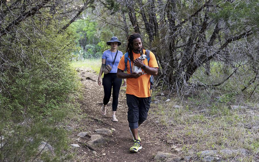 Robinson hikes with his girlfriend, Dawn Potts, 26, and their Chihuahua Lilah in Purgatory Creek Natural Area. 