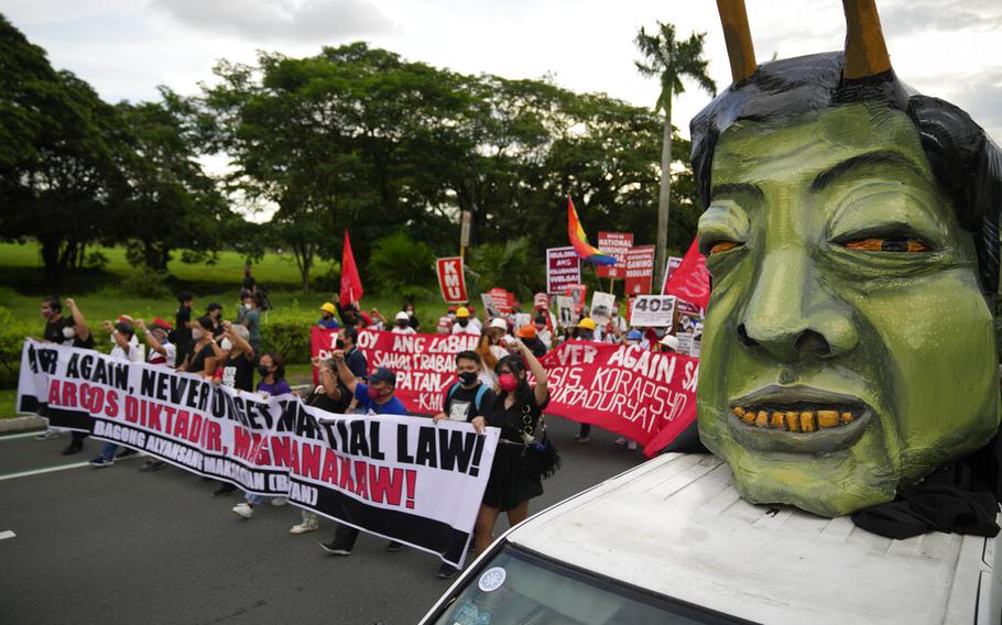 Human rights groups pass by an effigy of Philippine President Ferdinand Marcos Jr. as they mark the 50th anniversary of martial law at the University of the Philippines in Metro Manila, Philippines, Wednesday, Sept. 21, 2022. 