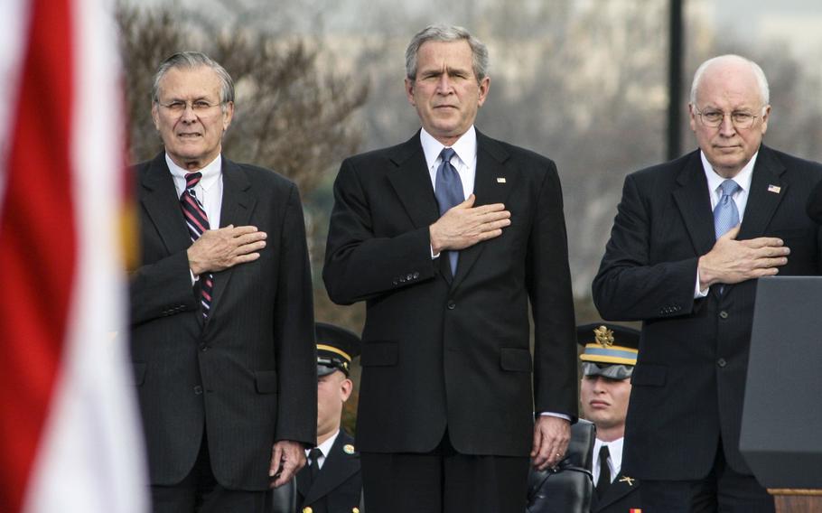 Secretary of Defense Donald Rumsfeld, President George W. Bush and Vice President Dick Cheney stand for the playing of the national anthem during Rumsfeld's retirement ceremony at the Pentagon in 2006.