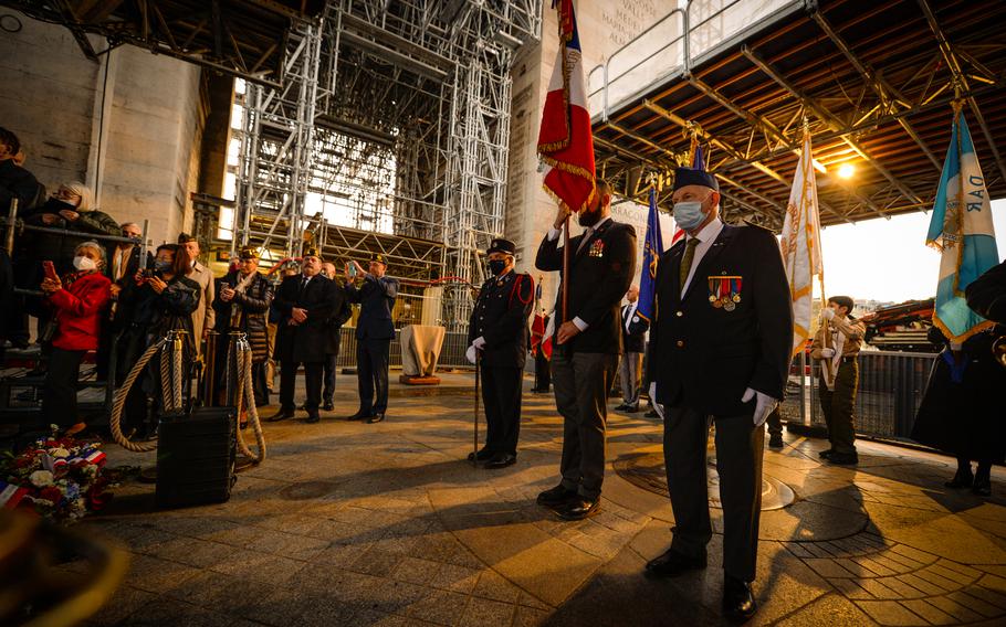 A French-American honor guard stands for the beginning of a wreath-laying ceremony at the Arc de Triomphe, in Paris, Oct. 26, 2021.