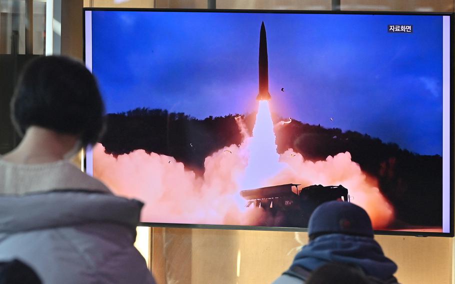 People watch a television screen showing a news broadcast with file footage of a North Korean missile test, at a railway station in Seoul on Jan. 30, 2022, after North Korea fired a "suspected ballistic missile" in the country's seventh weapons test this month according to the South's military.