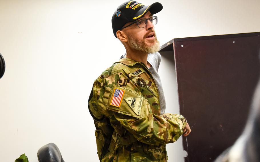 Jay Tenison, a former Army tanker who served in Iraq and was diagnosed in 2022 with terminal cancer, suits up before shooting an M1A2 Abrams tank at Fort Moore, Ga., on Dec. 5, 2023. Tenison lobbied the Army to shoot a tank one more time as his dying wish. 
