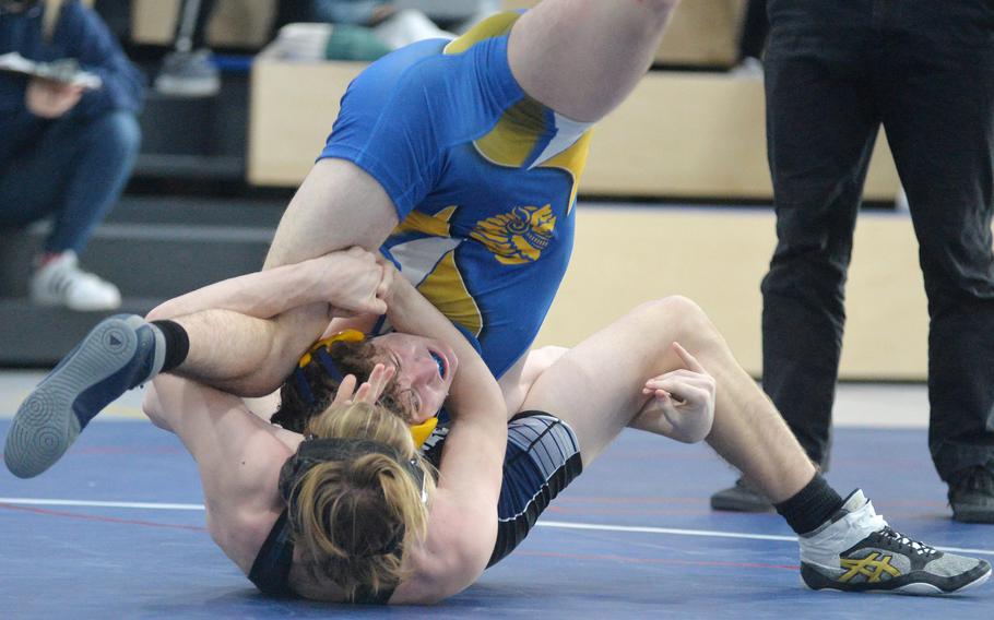 Josh Morse of Hohenfels, bottom, and Wiesbaden’s Patrick Iverson grapple in a 144-pound match at the high school Wrestling Tournament in Ramstein, Germany, Feb. 11, 2022. Iverson went on to win the match.