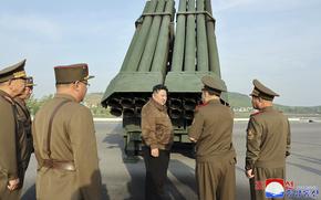 In this photo provided by the North Korean government, North Korean leader Kim Jong Un, center, supervises a test firing of a new multiple rocket launch system at an undisclosed place in North Korea on May 10, 2024.