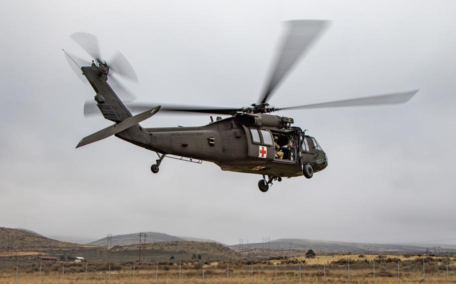 A UH-60 Black Hawk helicopter assigned to U.S. Army Air Ambulance Detachment- Yakima Training Center, 16th Combat Aviation Brigade flies above Yakima Training Center, Wash., on Dec. 7, 2021.  Troops used the aircraft Monday in a medical evacuation simulation in Naches, Wash.