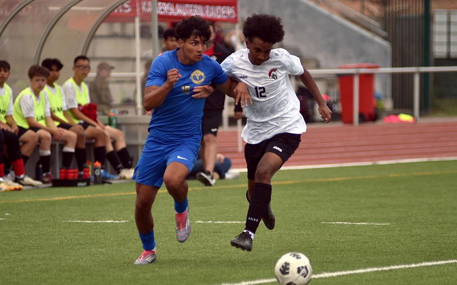 Ramstein midfielder Santiago Idarraga looks up as dribbles past Kaiserslautern defender Jevonne Ford during a Division I semifinal match at the 2025 DODEA European championships on May 21, 2025, at Kaiserslautern High School in Kaiserslautern, Germany.