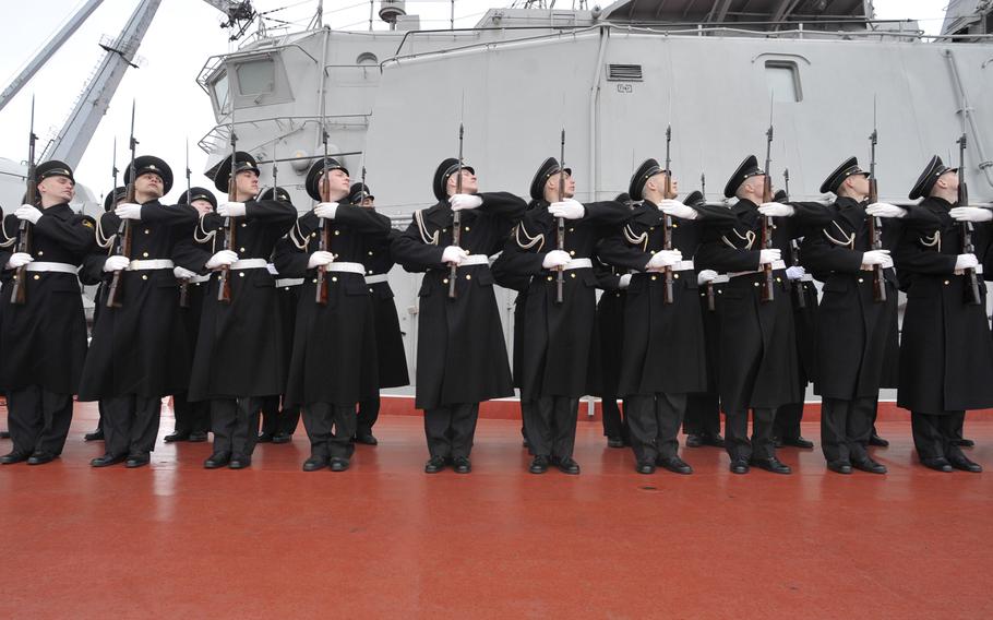 A Russian navy honor guard greets an American dignitary in front of the Russian navy battle cruiser Pyotr Velikiy in Severomorsk, Russia, in 2011. Naval analysts say the U.S. and its partners need more smaller warships to deter Russia effectively in the Baltic and Black seas. 