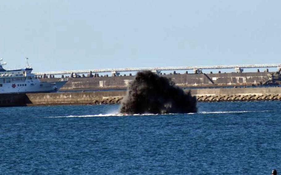 The Japan Maritime Self-Defense Force blows up hundreds of munitions left over from World War II, Tuesday, Dec. 14, 2021, about a half-mile from Naha Port’s Shinko Wharf. 