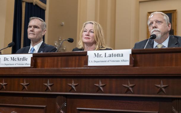Scholten, McArdle and Latona at the hearing table.