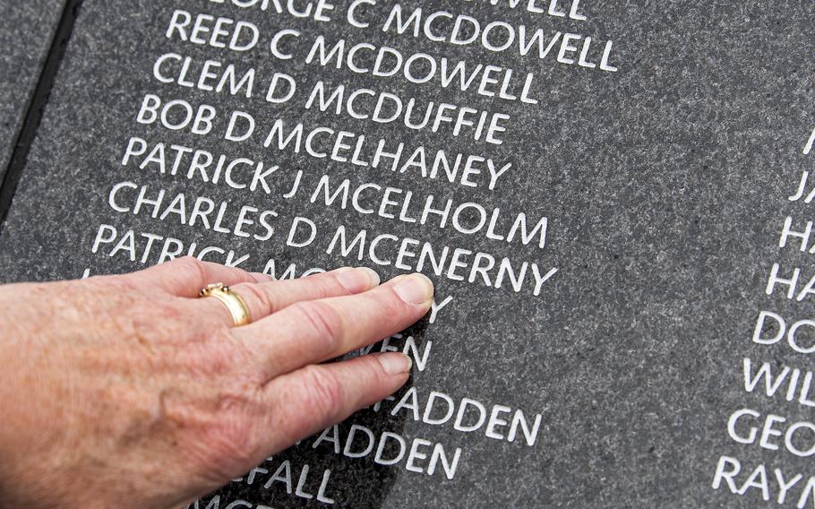 Anne McEnerny-Ogle points to the name of her uncle, Charles D. McEnerny, engraved on the new Wall of Remembrance at the Korean War Memorial in Washington, D.C., on Tuesday, July 26, 2022.