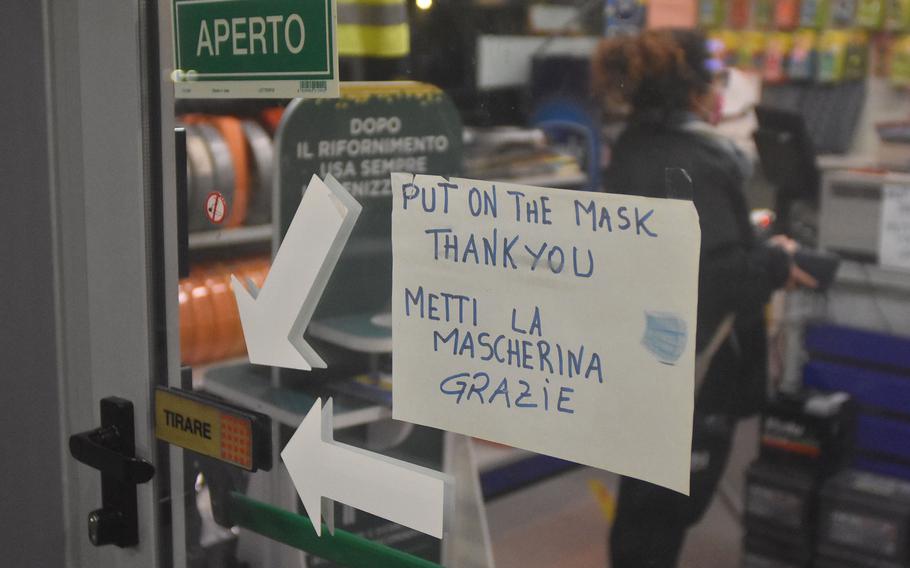 A sign requiring masks at an Agip gas station near Aviano Air Base, Italy, Nov. 29, 2021. The sign has been up for those coming inside since last year, but new Friuli Venezia-Giuli restrictions meant customers filling up their cars outside also were required to wear masks. Those staying in their cars who were willing to pay more to have their gas pumped could still go maskless. 