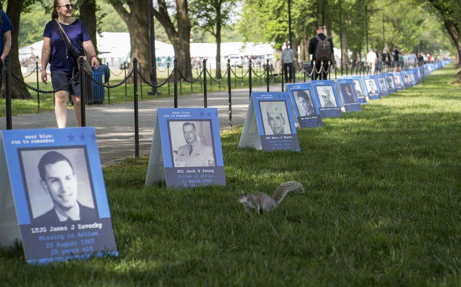 Hundreds of posters of service members who died during the Vietnam War are lined beside the Lincoln Memorial Reflecting pool on Thursday, May, 11, 2023, the first day of a three-day event in Washington, D.C., to honor Vietnam War veterans. The posters were placed along the National Mall space by the nonprofit group wear blue: run to remember, a running community that honors the service of U.S. military members and those impacted by the loss of those who died while serving in the military. 
