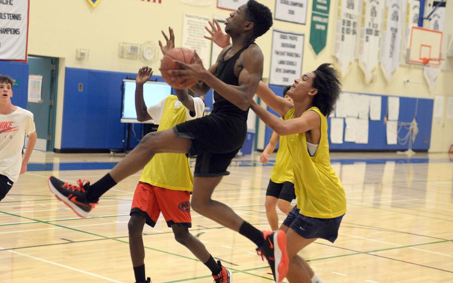 Junior DeShawn Bryant soars to the basket against Yokota teammates.