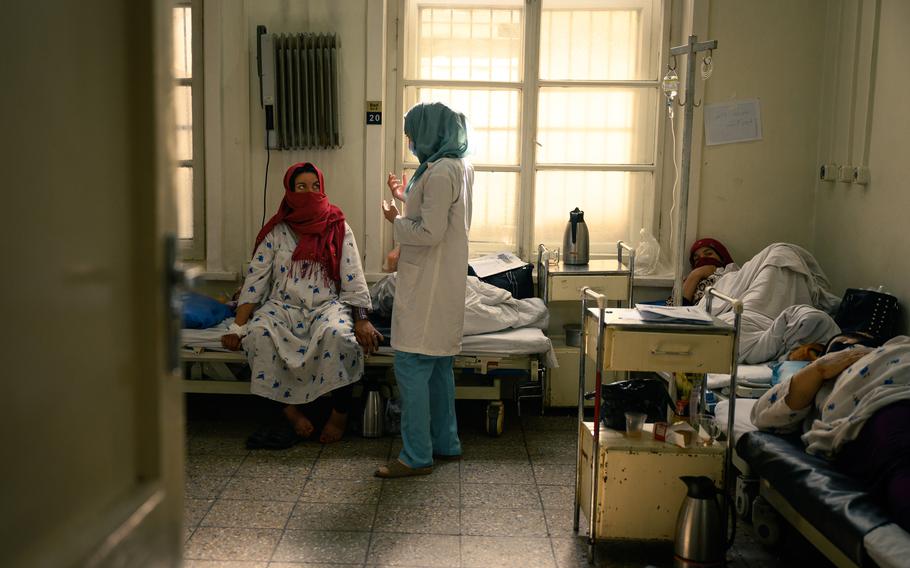 Dr. Asya Pardiz, a 3rd-year resident check on patients after their C-sections) at the Rabia Balkhi public women's hospital, one of Kabul's busiest, on October 24, 2022. Despite the ongoing training of 55 residents, the hospital is facing an uptick in patients which has spread the remaining doctors thin.