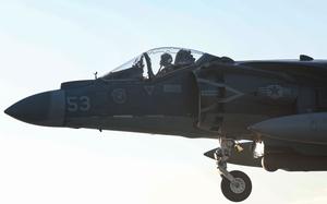A closeup of the pilot’s seat of a fighter jet in the air.
