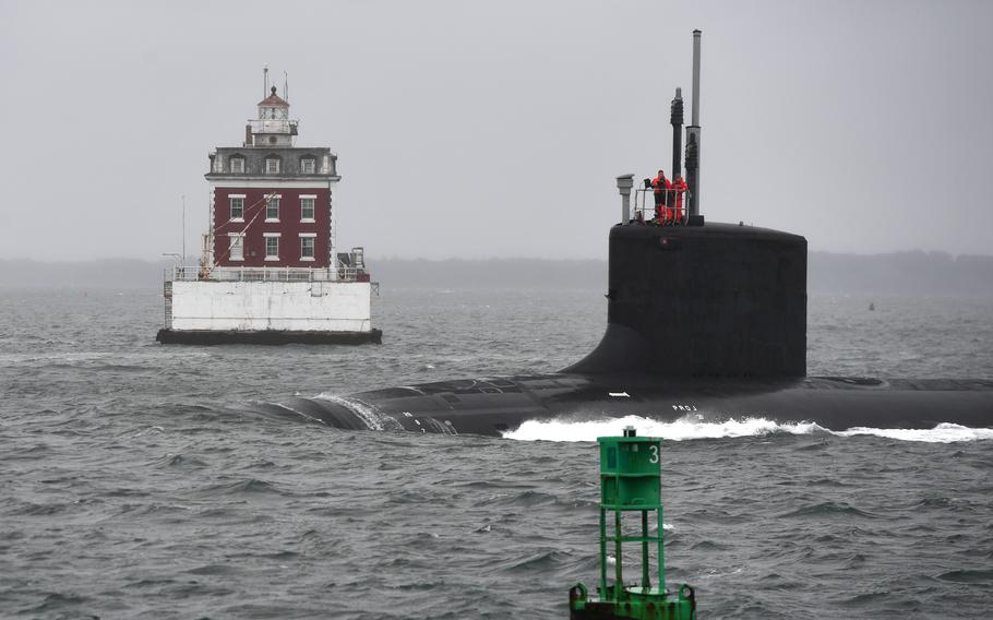 The USS Oregon, a Virginia-class submarine, passes the New London Ledge Lighthouse near Groton, Conn., in October 2022. The Navy’s fiscal 2025 budget calls for adding a Virginia-class attack submarine to the fleet. 
