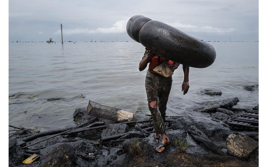 A fisherman, covered in oil and petroleum, exits Lake Maracaibo along the polluted shores of Cabimas, Venezuela. The collapse of the state-run oil company's infrastructure has destroyed the fish stocks and thoroughly contaminated the region.