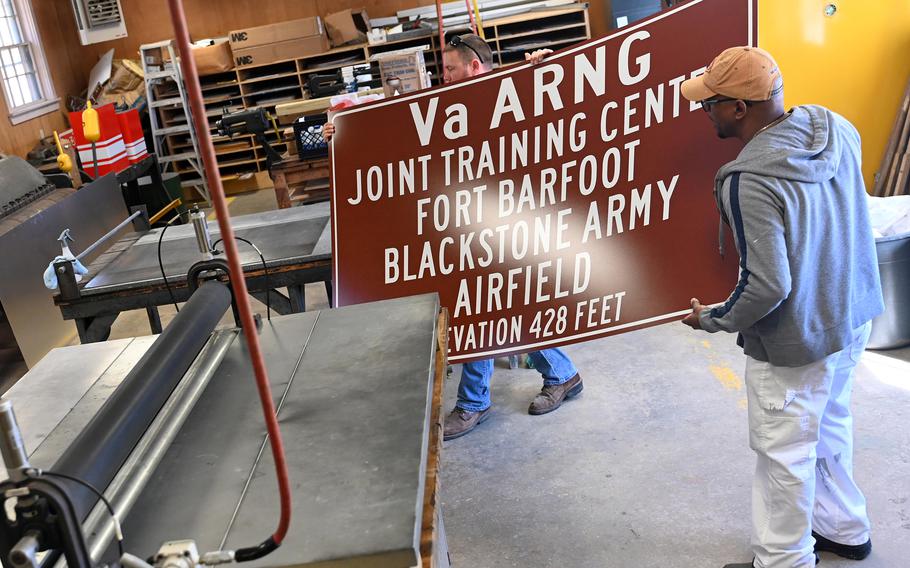 Employees make signs using the “Fort Barfoot” name to replace existing “Fort Pickett” signs on March 6 at Fort Pickett, Va.