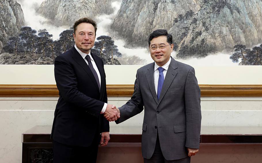 In this photo taken Tuesday, May 30 2023 and released by Ministry of Foreign Affairs of the People's Republic of China, China's Foreign Minister Qin Gang, right, poses for photos with Tesla Ltd. CEO Elon Musk in Beijing. China’s foreign minister met Tesla Ltd. CEO Elon Musk on Tuesday and said strained U.S.-Chinese relations require “mutual respect,” while delivering a message of reassurance that foreign companies are welcome.