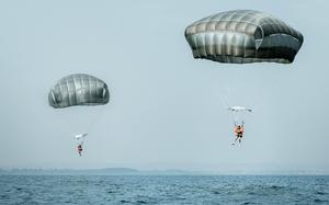 U.S. paratroopers practice jumping into water at Lake Garda in Italy on April 10, 2025. The skill helps them deploy to areas where traditional drop zones are unavailable.