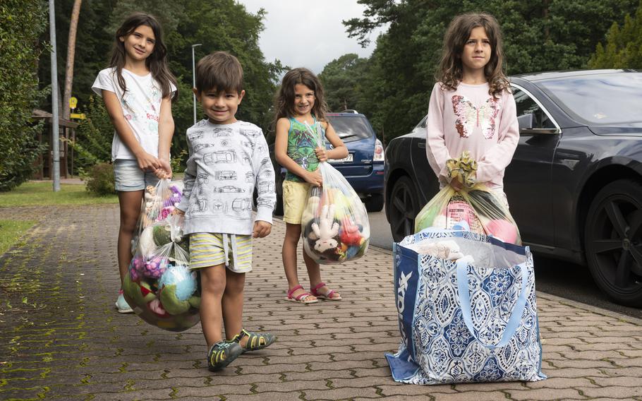 Nadia Perez, left, and her siblings Rodrigo, Yvette and Astrid bring donations to a drive for Afghan refugees at Ramstein Air Base on Aug. 26, 2021. 