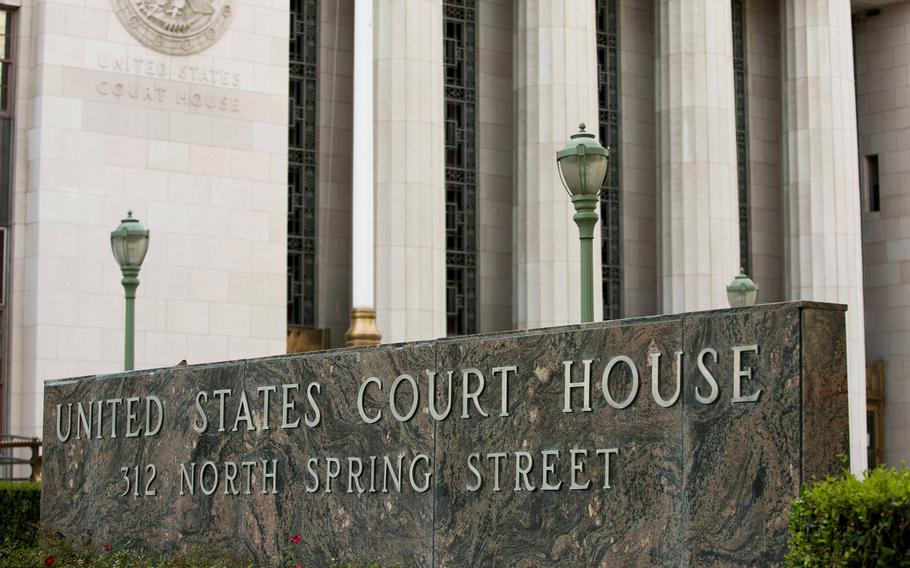 A marble sign reading “United States Court House 512 North Spring Street” in front of a stone government building with large columns.