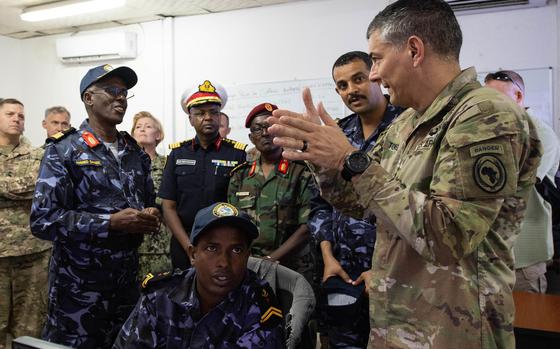 U.S. Army Gen. Stephen J. Townsend, commander of U.S. Africa Command, speaks to Djiboutian navy commander Col. Ahmed Daher Djama, left, and others during a visit to Djibouti in November 2019.