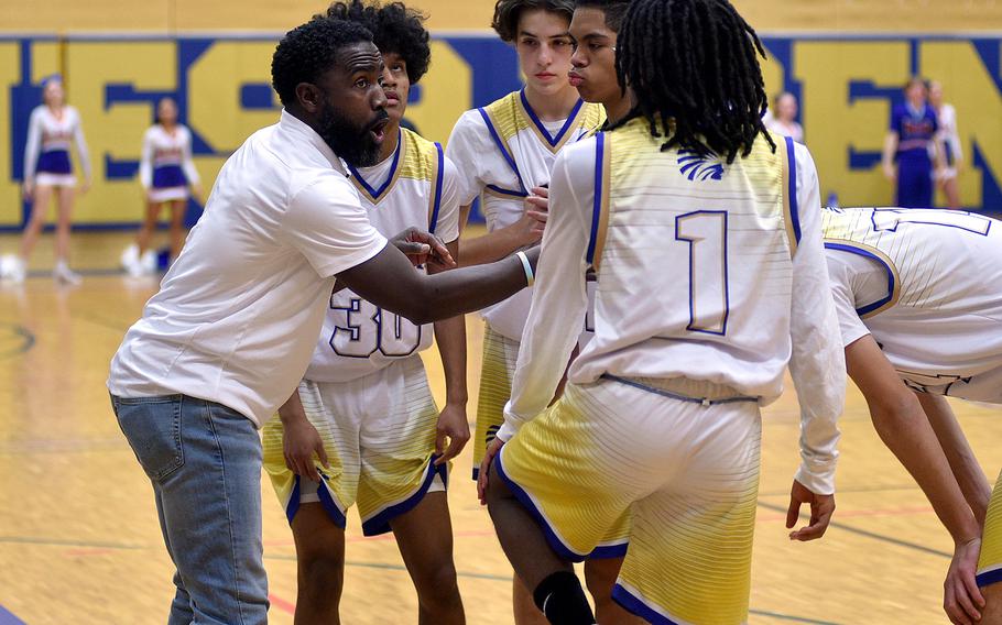 Wiesbaden coach David Brown talks with his players during a timeout at Thursday's game against Ramstein at Wiesbaden High School in Wiesbaden Germany. The Warriors lost 53-48.