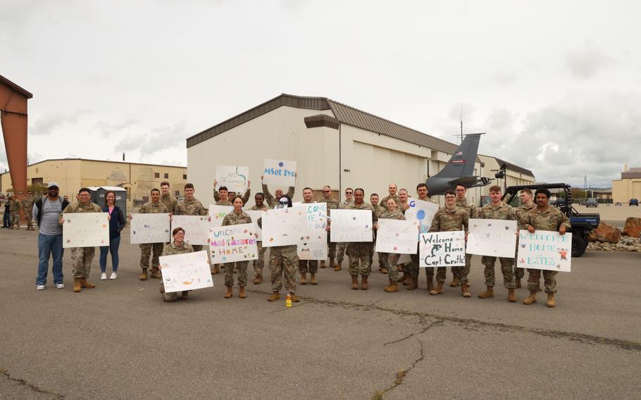 U.S. Air Force airmen and Beale teammates show their posters 
