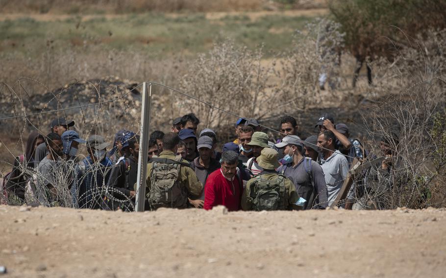 Israeli troops carry out security checks on Palestinian laborers in the West Bank village of Jalameh, on Monday, Sept. 6, 2021. Israel on Tuesday launched airstrikes on Gaza sites after incendiary balloons were sent into Israel.