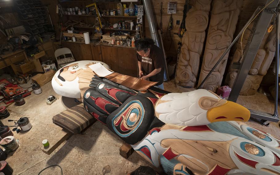 Jewell James of the Lummi Nation works on a 25-foot totem pole he helped make as head carver for the "House of Tears" carvers. The pole is making a cross-country trip with a crew of travelers in July from Washington state to Washington D.C. to raise awareness about Native American issues and sacred sites. 