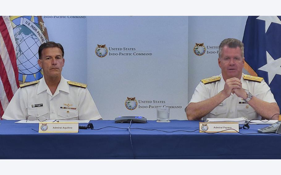 Adm. John Aquilino, left, head of U.S. Indo-Pacific Command, and Adm. Samuel Paparo, commander of U.S. Pacific Fleet, speak with reporters at Camp H.M. Smith, Hawaii, on June 30, 2022.