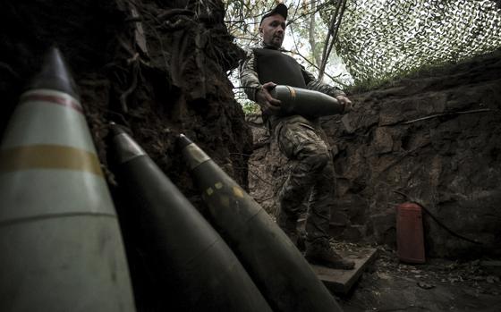FILE - In this photo provided by Ukraine's 24th Mechanized Brigade press service, a serviceman prepares to fire a howitzer toward Russian army positions near Chasiv Yar, Donetsk region, Ukraine, June 14, 2025. (Oleg Petrasiuk/Ukraine's 24th Mechanized Brigade via AP, File)