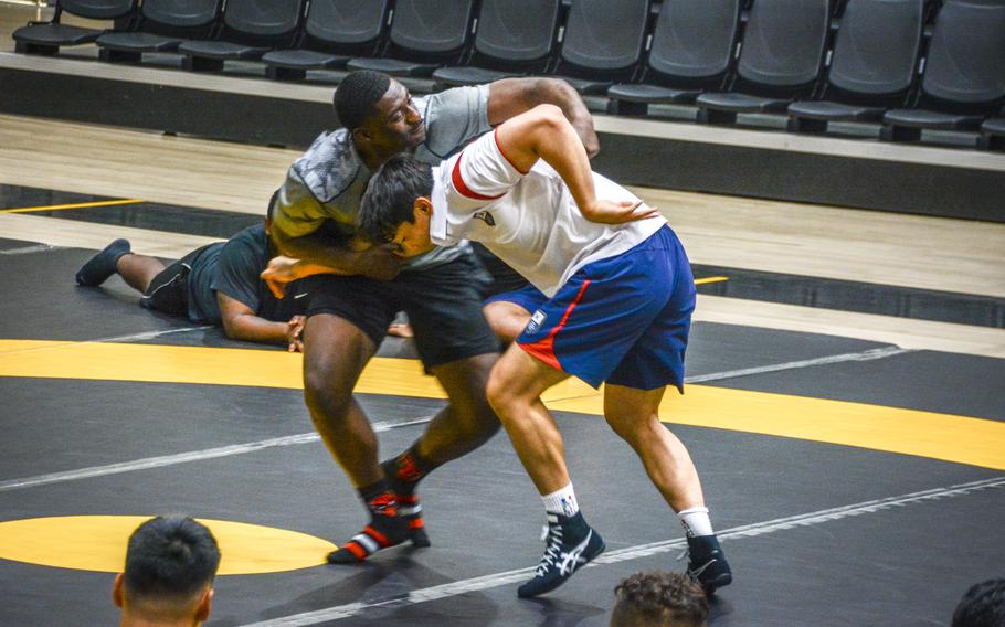 Seo Bum Gue, a South Korean national team wrestler, spars with a U.S. Army soldier during a wrestling seminar in Carey Fitness Center at Camp Casey, South Korea, June 18, 2024.