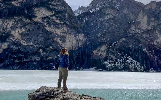 Kimberly standing on a rock looking out to mountains