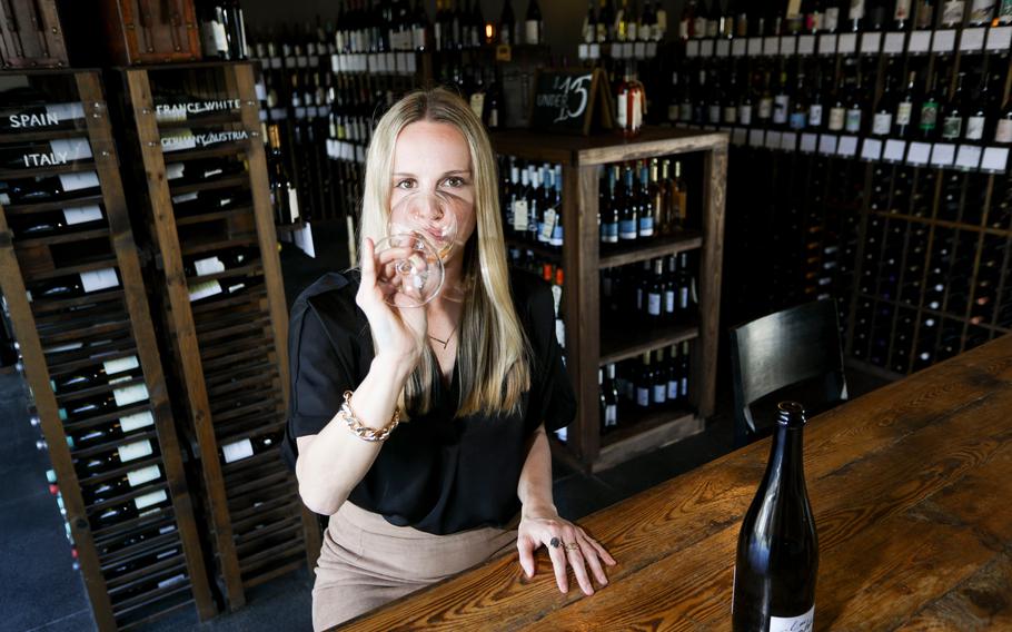 Wine rep Tara Simmons poses for a portrait at Cru Cellars in Tampa on Feb. 12, 2021. Simmons knew she contracted COVID-19 when she couldn't smell the food she poured for her dogs a few days after the New Year's. "It is the weirdest symptom of any illness I've ever experienced to be able to breathe out of your nose, but not smell," Simmons said. 