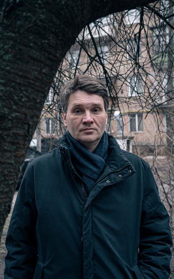 Oleksii Kruchukov, a washing machine repairman, waits in line outside a recruitment office in Kyiv. He said he was ordered to report there after police broke up a fight he got into.