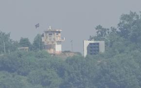 FILE - A North Korean military guard post, left, and loudspeaker are seen from Paju, South Korea, near the border with North Korea, June 12, 2025. (AP Photo/Ahn Young-joon, File)