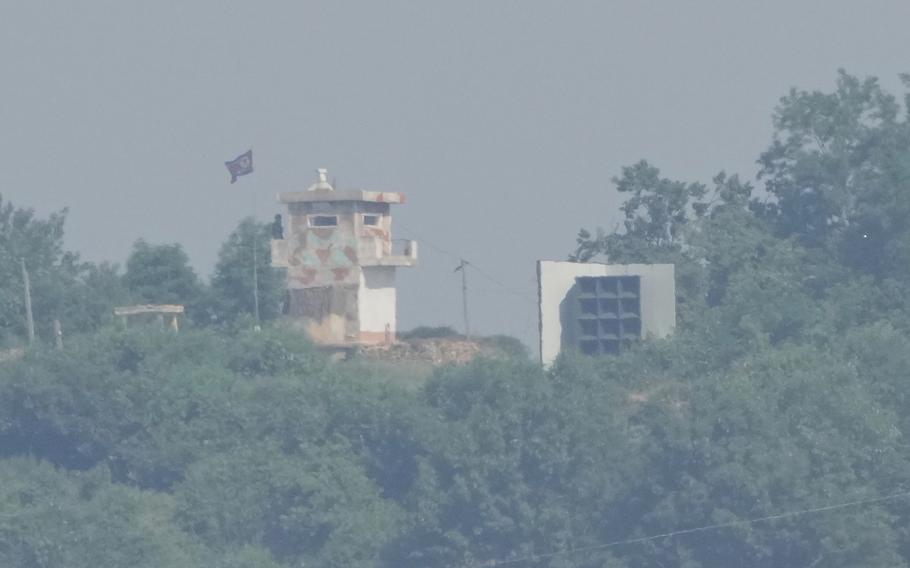 A North Korean military guard post stands among trees. It’s photographed from a distance. 